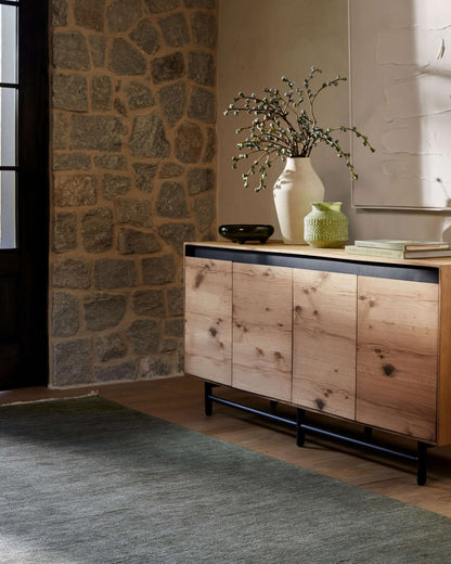 Molander Dining Sideboard in a rustic stone wall setting, blending modern design with natural elements.
