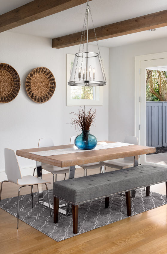 Modern dining room with clear glass cone pendant light over wood table.