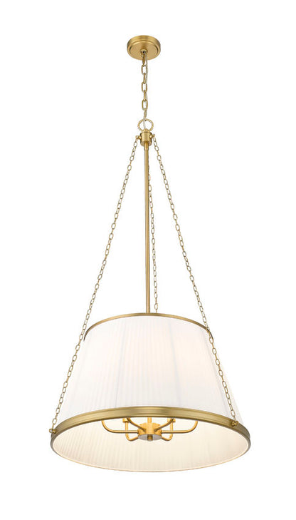 close-up view of modern gold pendant light showing pleated white shade and bulb detail.