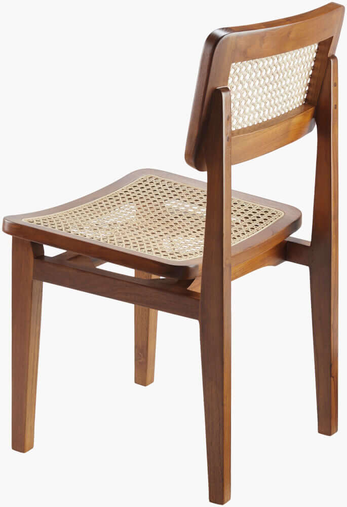 Angled view of the Surya Arxan dining chair in dark brown finish, featuring the rattan seat and backrest.