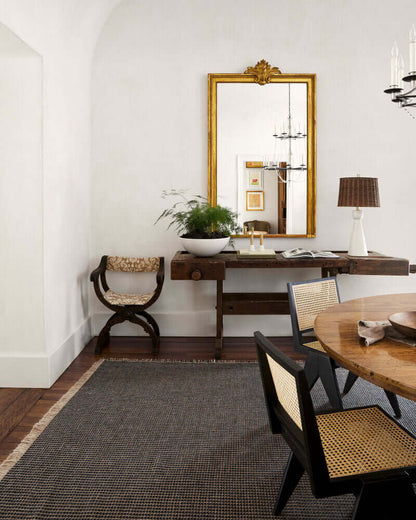 Rattan dining room chair paired with a rustic wooden dining table, adding texture and style to the space.