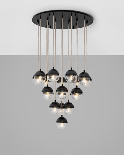 Illuminated black gunmetal cluster chandelier with glowing glass globes.