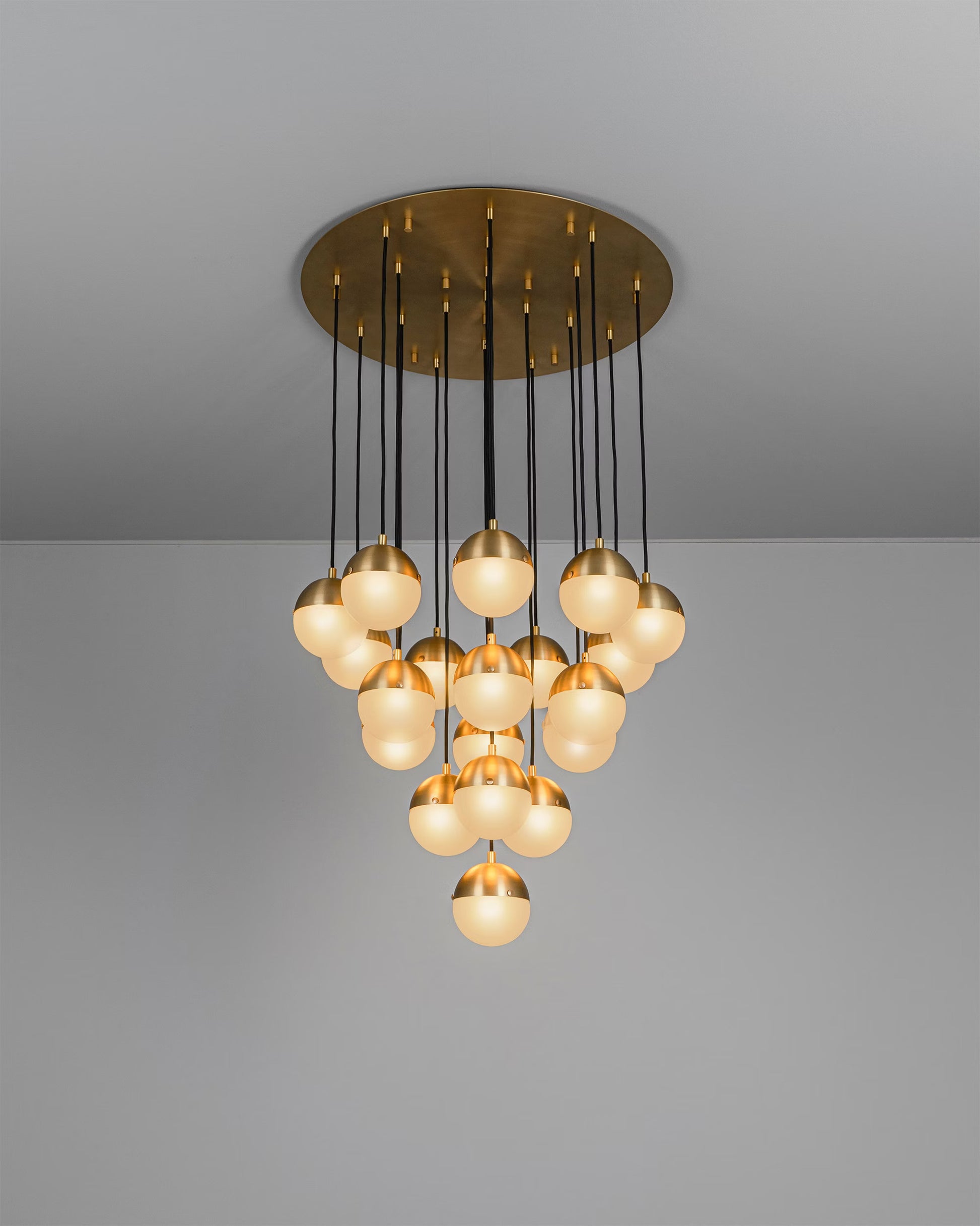 Molecule Cluster 19 Chandelier illuminated with frosted glass globes and burnished brass frame.