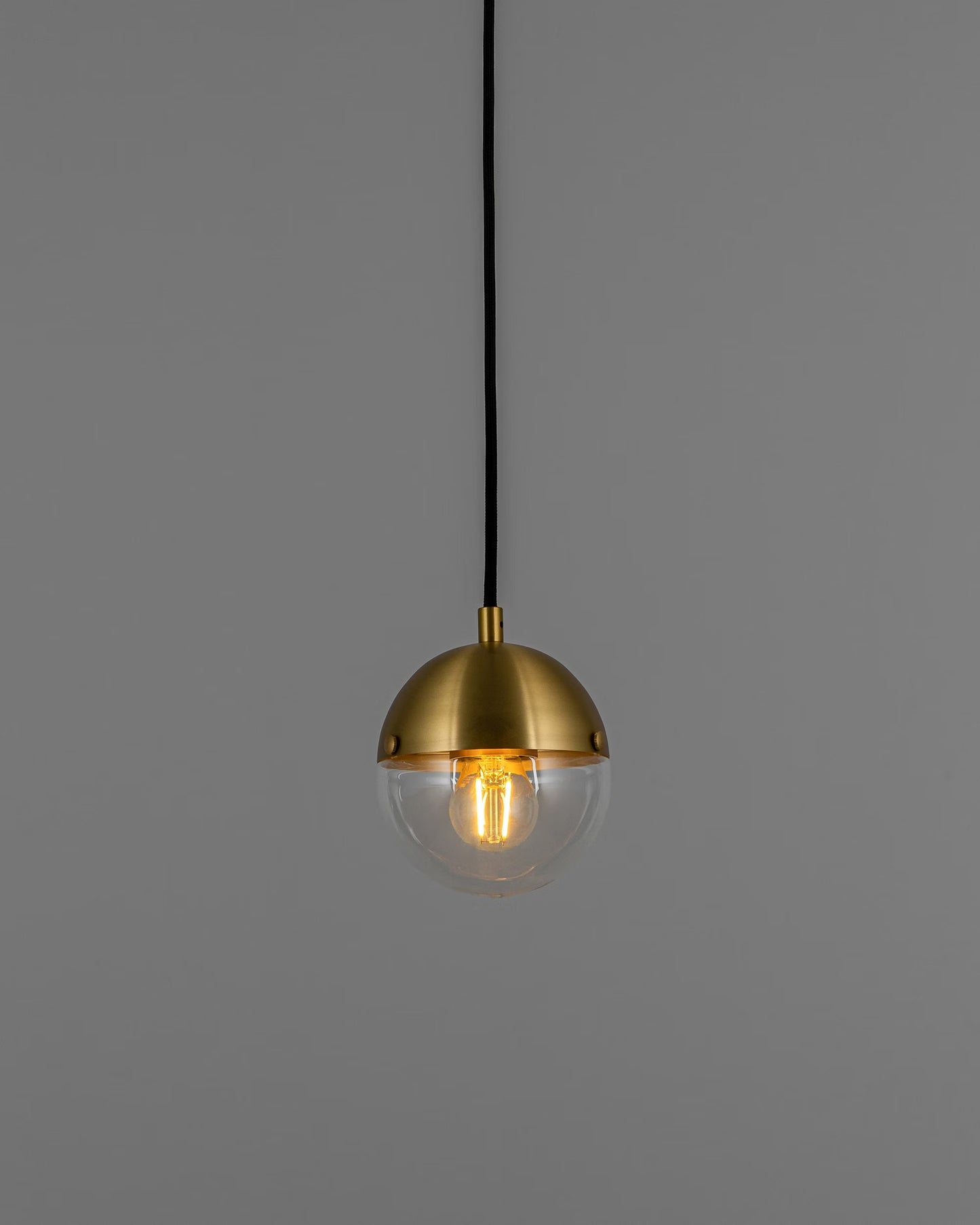 Molecule Pendant Light illuminated, showcasing warm glow and transparent glass.