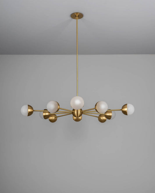 Molecule Spark Round 10 Chandelier with frosted glass globes and brass arms, turned off.