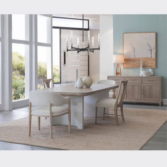 The Montara natural dining table set in a beautifully decorated dining room, highlighting its warm oak finish and elegant design.