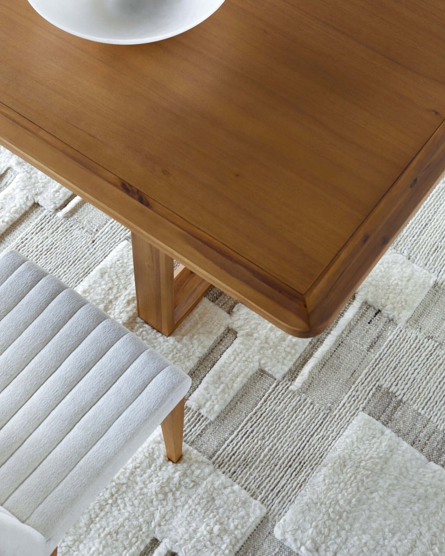 Close-up of Northbank Dining Table top showing rich acacia wood grain.