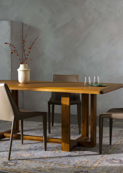 Dining setup featuring the Northbank Dining Table with chairs and a decorative vase.