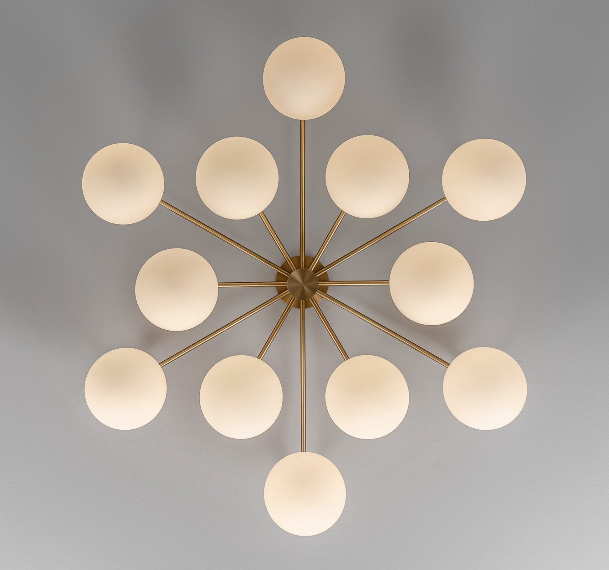 Orion Round Chandelier illuminated with Opal Matte Glass for a warm ambiance.