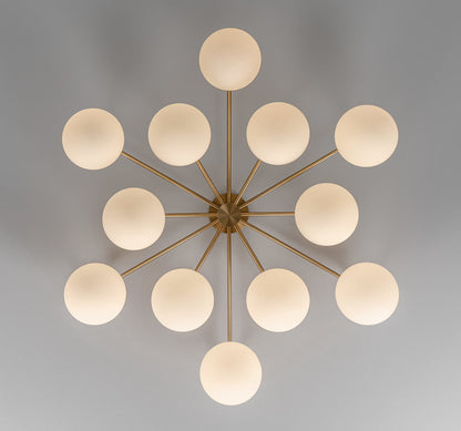 Orion Round Chandelier illuminated with Opal Matte Glass for a warm ambiance.