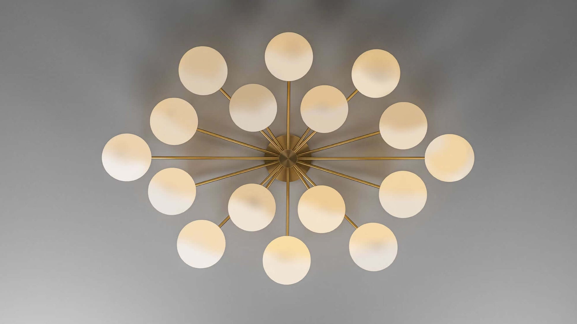 Top view of Orion Oval Chandelier with glowing opal matte globes and burnished brass frame.