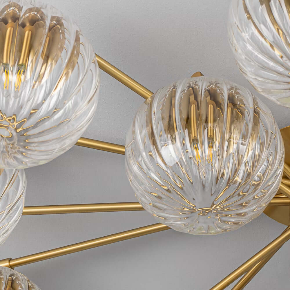 Orion Oval Chandelier with ribbon transparent glass globes, close-up on intricate detailing.