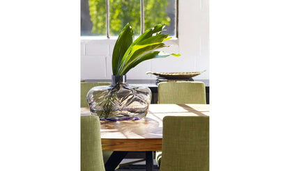 Parq Oval Rustic Dining Table with a glass vase centerpiece in a bright room