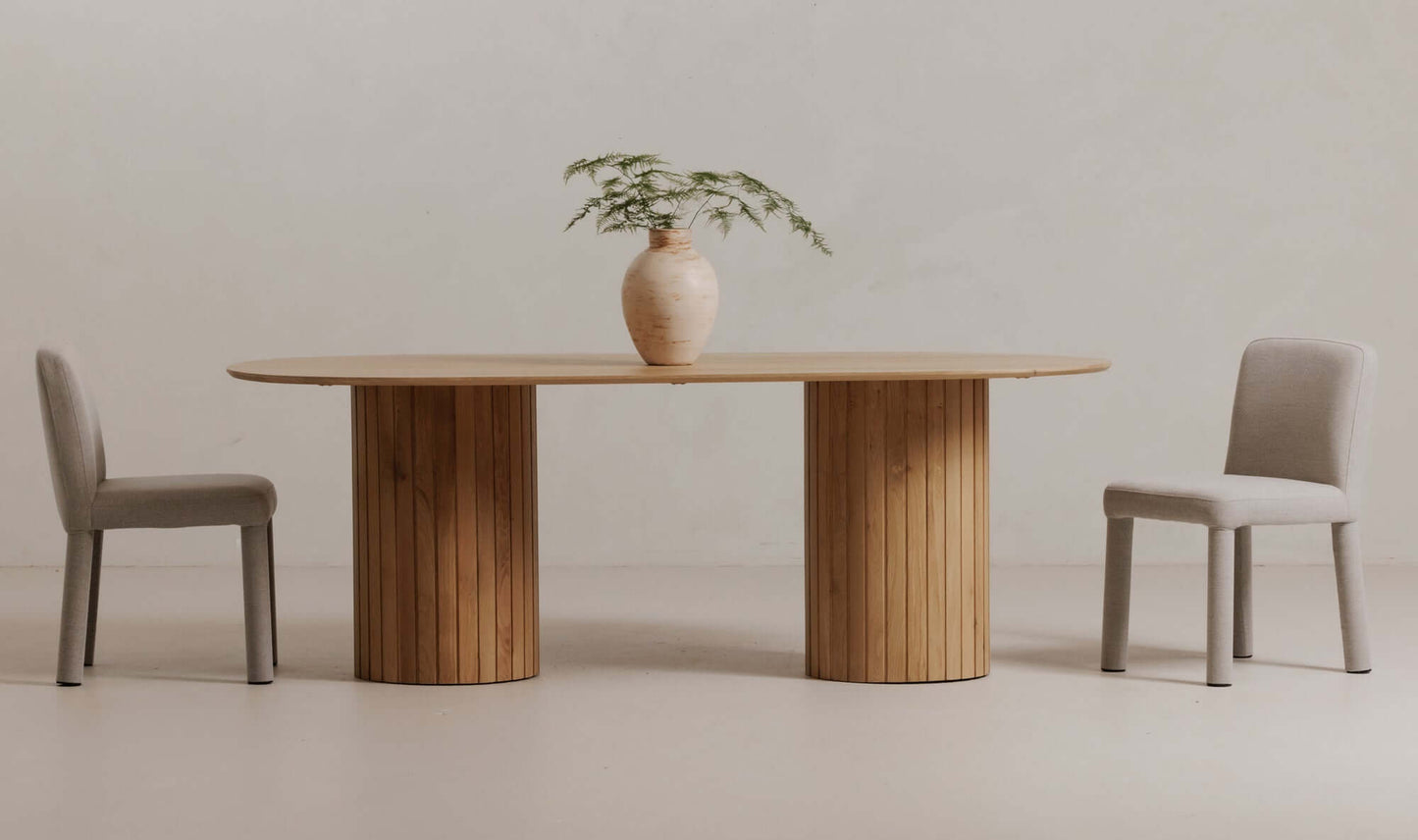 Light grey contemporary dining chair in a minimalistic dining setup.