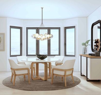 Modern dining room with round table, wooden base, white top, and four upholstered chairs.