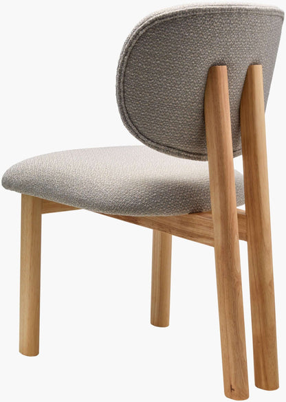 Angled view of the Surya Rena Dining Chair, showing the smooth curves and elegant design of the upholstered modern dining chair.