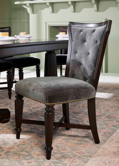 Close-up of the Revival Traditional Upholstered Dining Chair, showcasing diamond button tufting and brass nailhead trim.