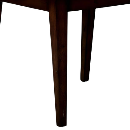 Detailed view of the legs of a brown wood dining chair with a dark wood finish.