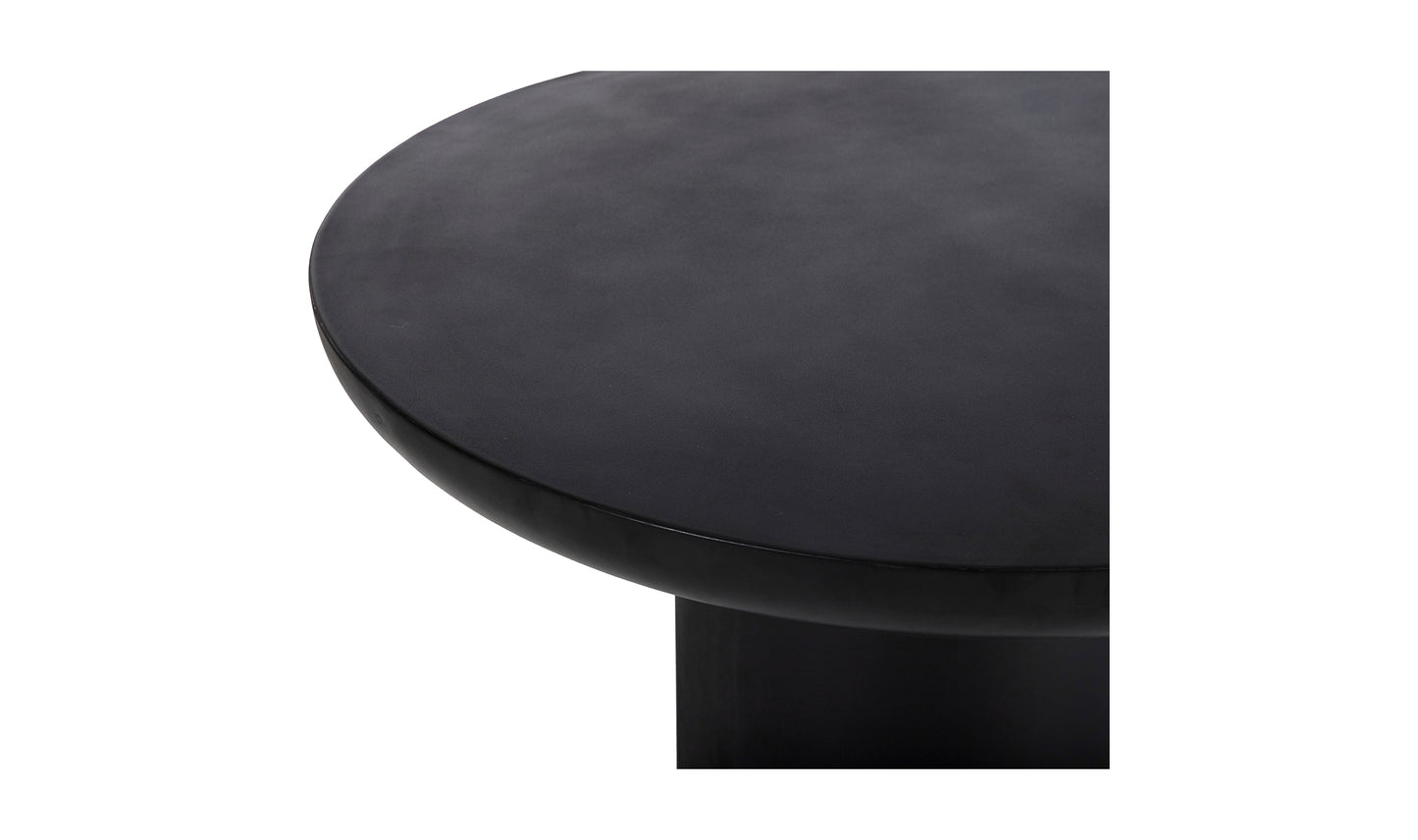 Close-up of the Rocca black concrete dining table’s smooth concrete surface, highlighting its sleek finish