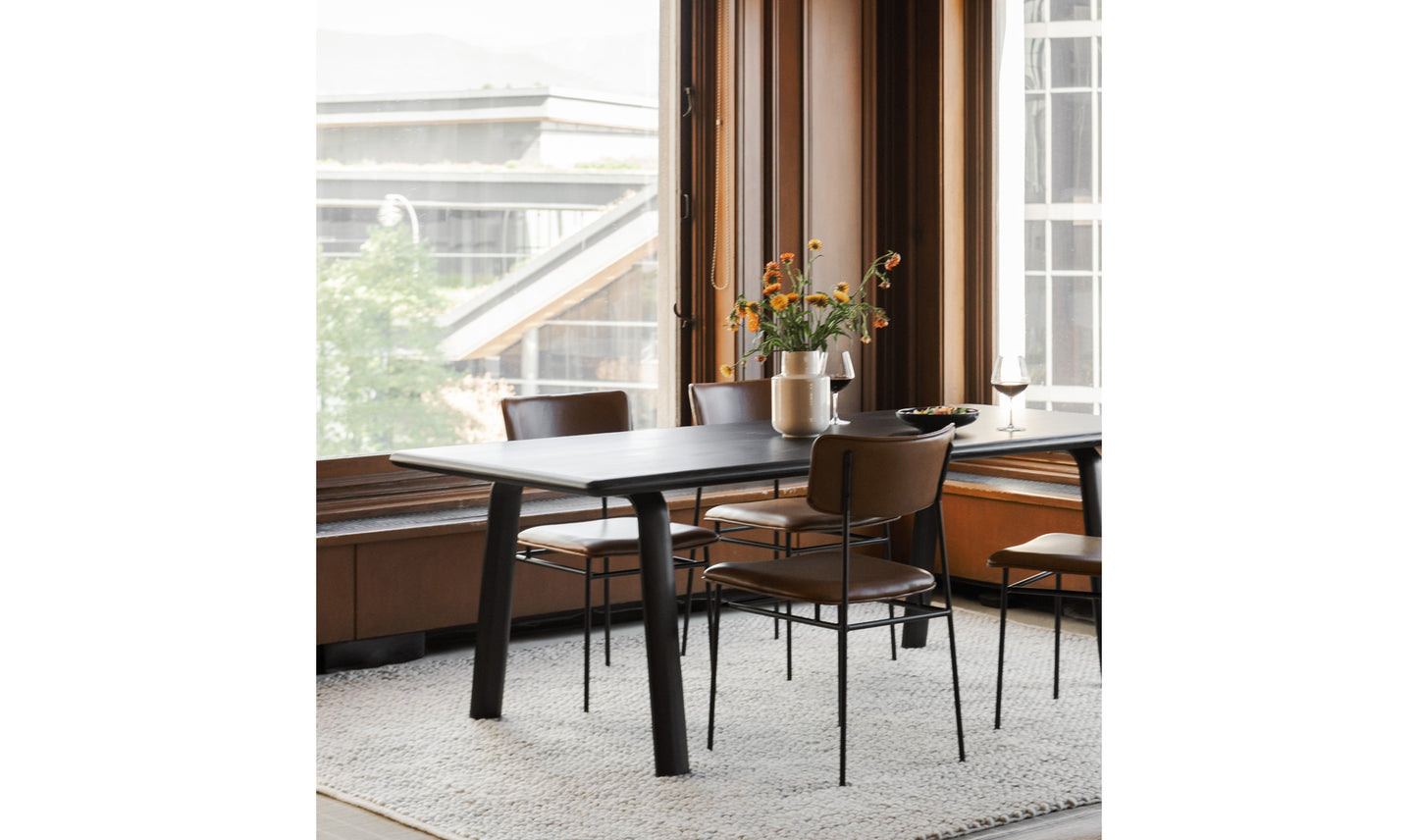 Sailor modern leather dining chair in a minimalist dining room.