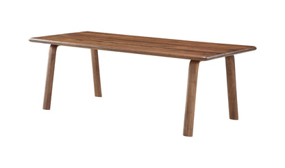 Angled view of Malibu Dining Table, showing sleek Scandinavian design in solid walnut wood with a matt lacquer finish.