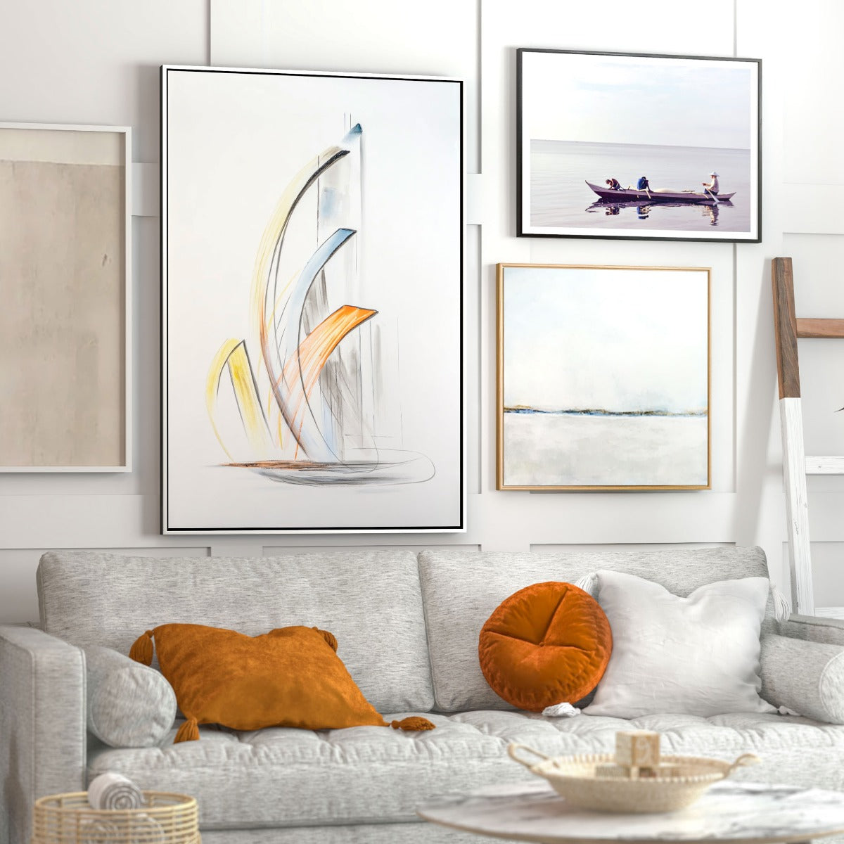 Framed abstract sailboat artwork hanging above a cozy sofa with neutral decor.