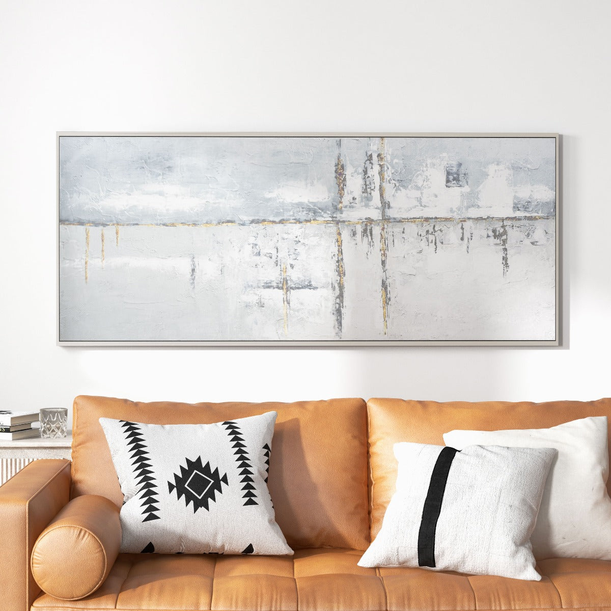 Elegant grey abstract painting with gold accents above a tan sofa.