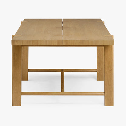 Side view of Soren Oak Dining Table displaying rubberwood legs and modern farmhouse design.