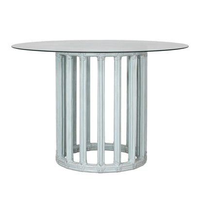  Front view of a cloud blue round metal table base with rattan and glass top.