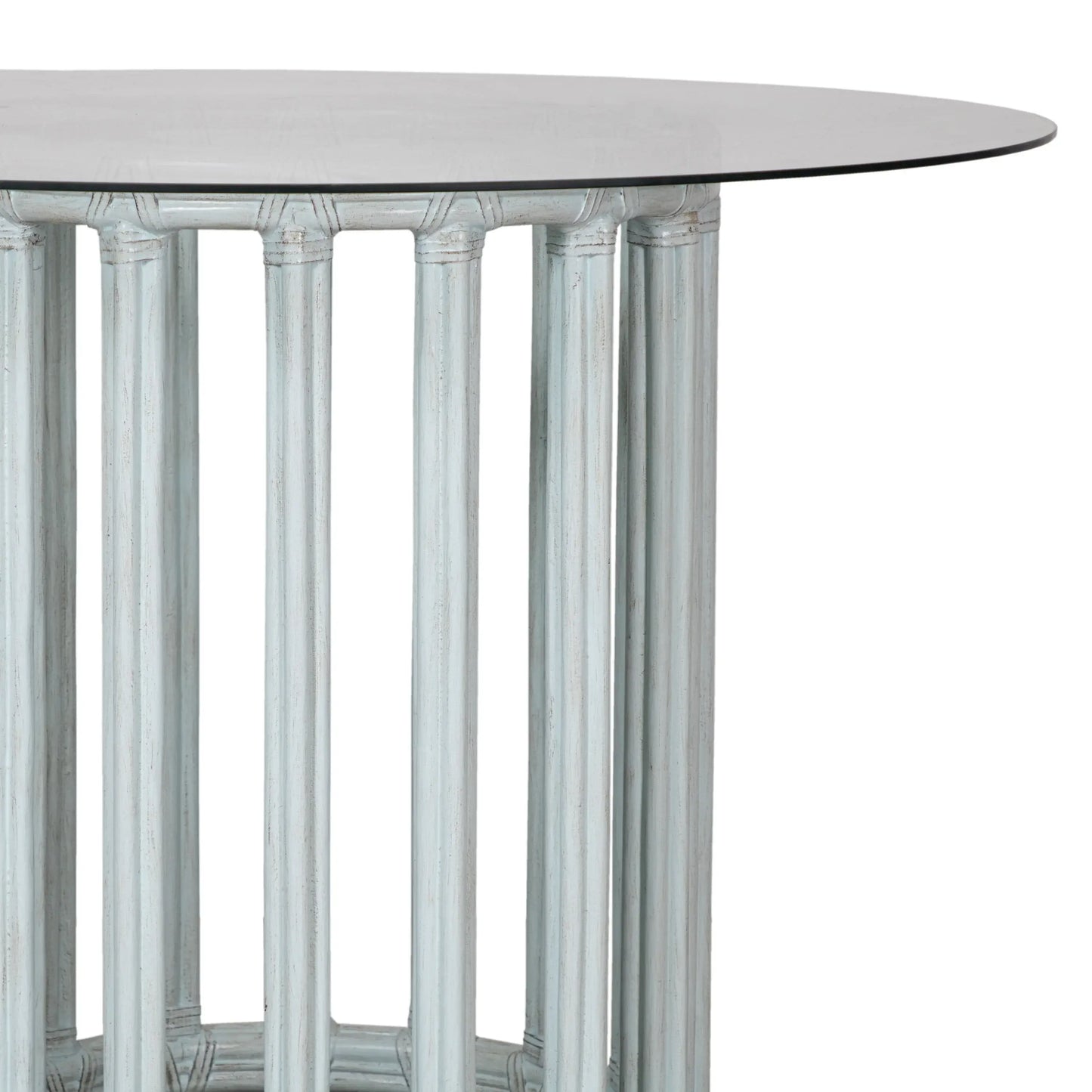 Close-up of rattan dining table base only, with round metal frame and glass top