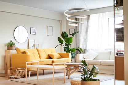 Oval spring pendant light titanium silver above modern living room with yellow sofa