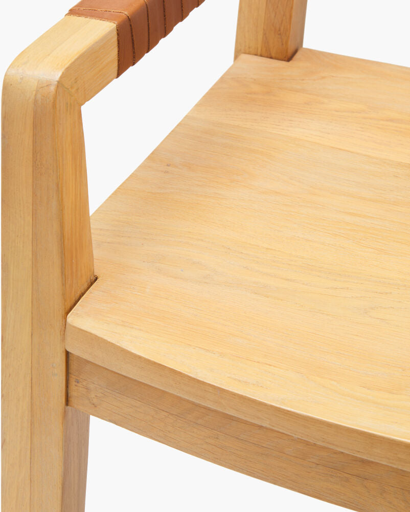 Close-up of seat edge of the Uintah oak wood dining arm chair, highlighting craftsmanship and smooth finish.