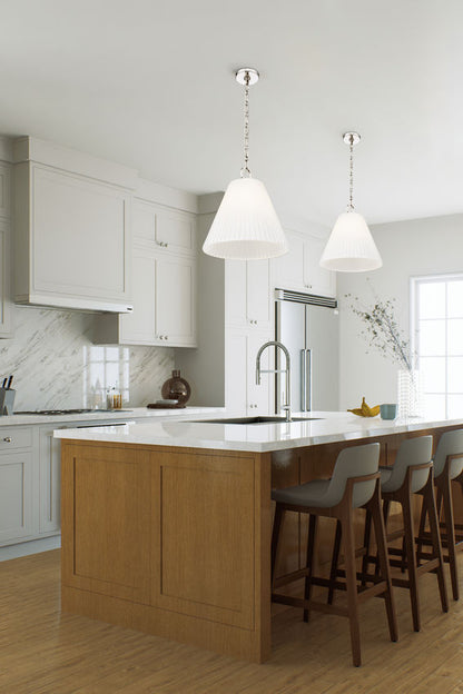 white kitchen with polished nickel pleated pendant lights.